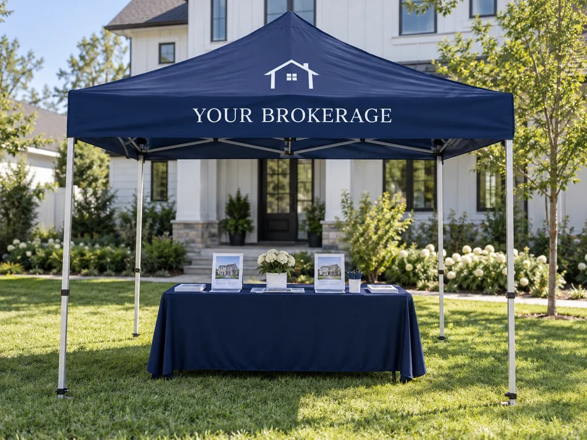 Sample branded pop-up event tent on a lawn outside a model home